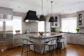 A grey and black color schemed kitchen