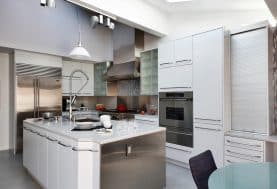 A spacious modern, white and silver kitchen.