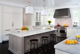 a gray and white kitchen with a large center island